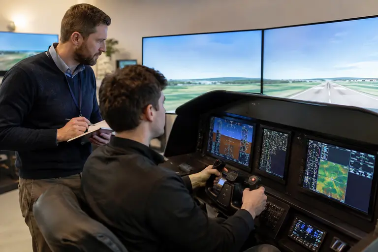 Flight instructor observing a crew during simulator training